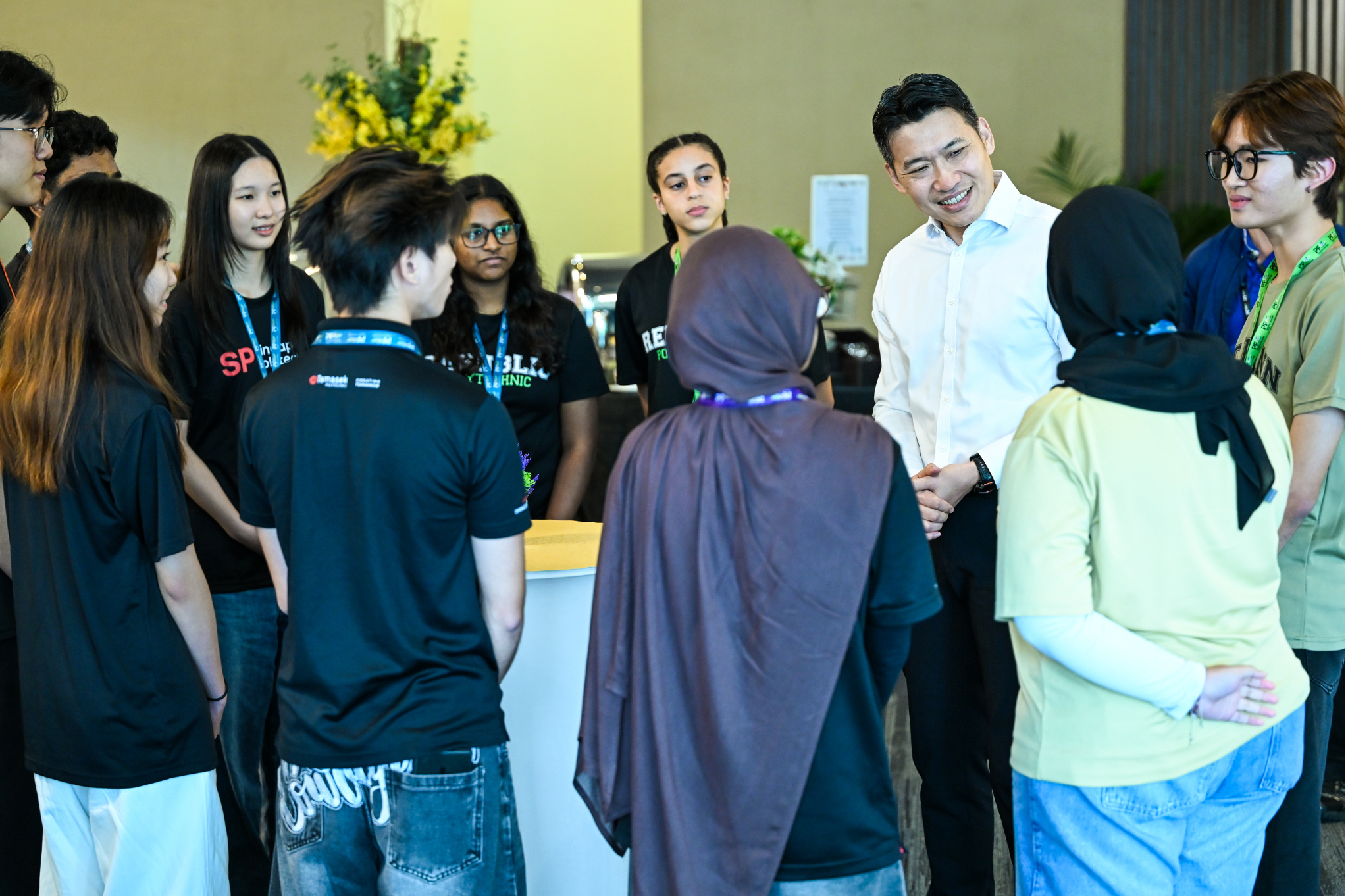 Selected student delegates engaging Minister David Neo in a conversation following the Opening Ceremony.